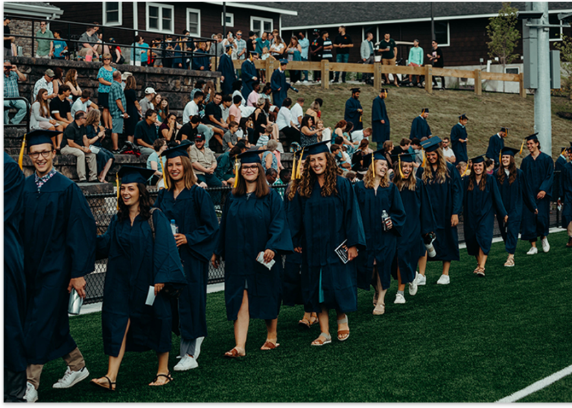 people walking in graduation gowns and caps