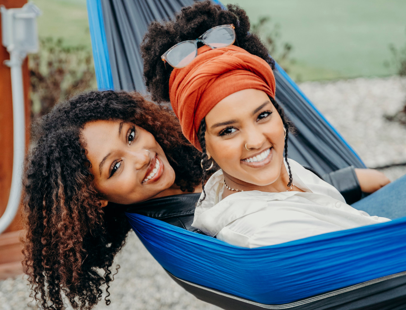 Two women sitting in a hammock